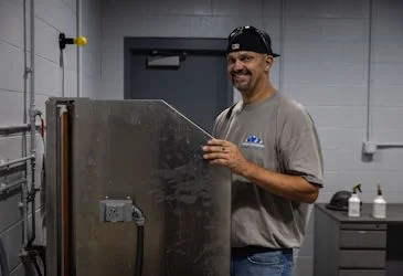 confident young carpenter doing job